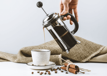 Man pouring french press coffee into cup