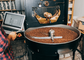 Coffee beans being roasted in the industrial coffee roaster