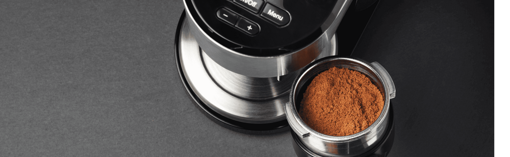 coffee grinder grinding whole roasted coffee beans