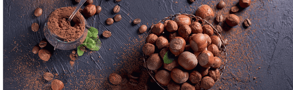 Hazelnuts and coffee beans are shown with both their powders