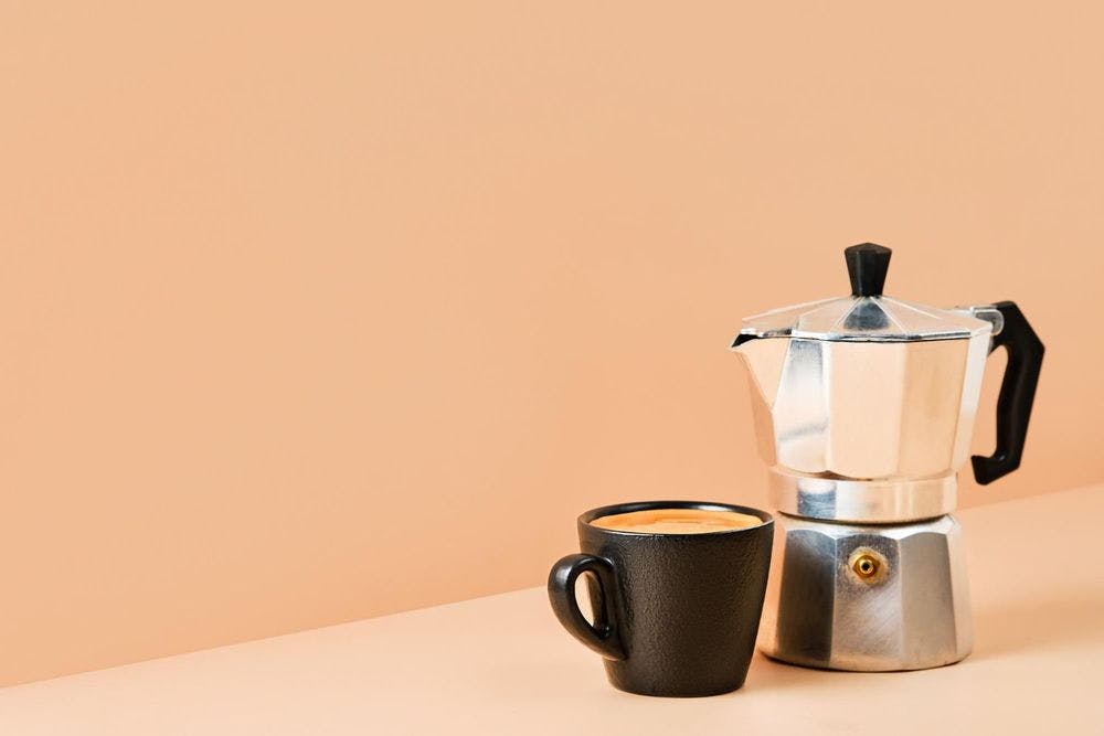 Cup with espresso coffee pot