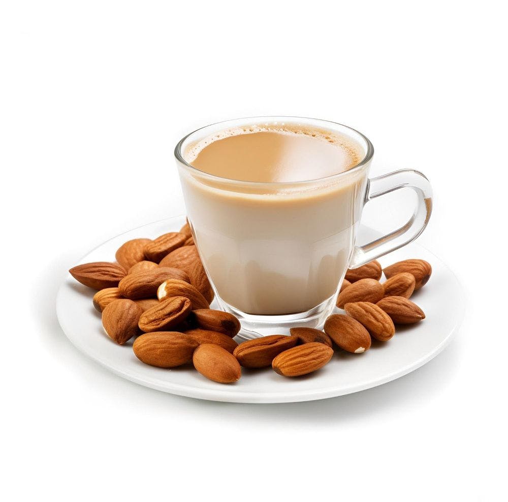 Coffee served in a small glass cup with almonds in the surrounding