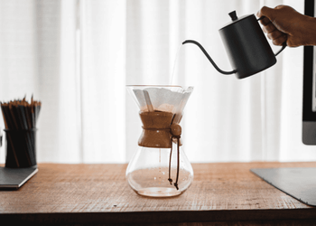 Man brewing Chemex using a white paper filter