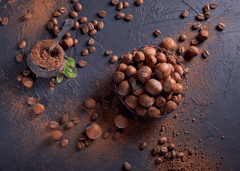 Hazelnuts and coffee beans are shown with both their powders