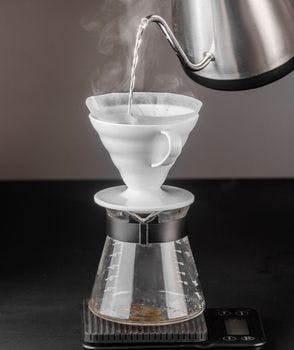 Barista brewing coffee using Hario V60
