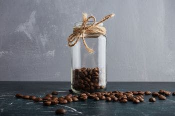 Brown coffee beans in mason jar