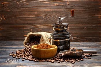 Coffee grinder shown with roasted beans